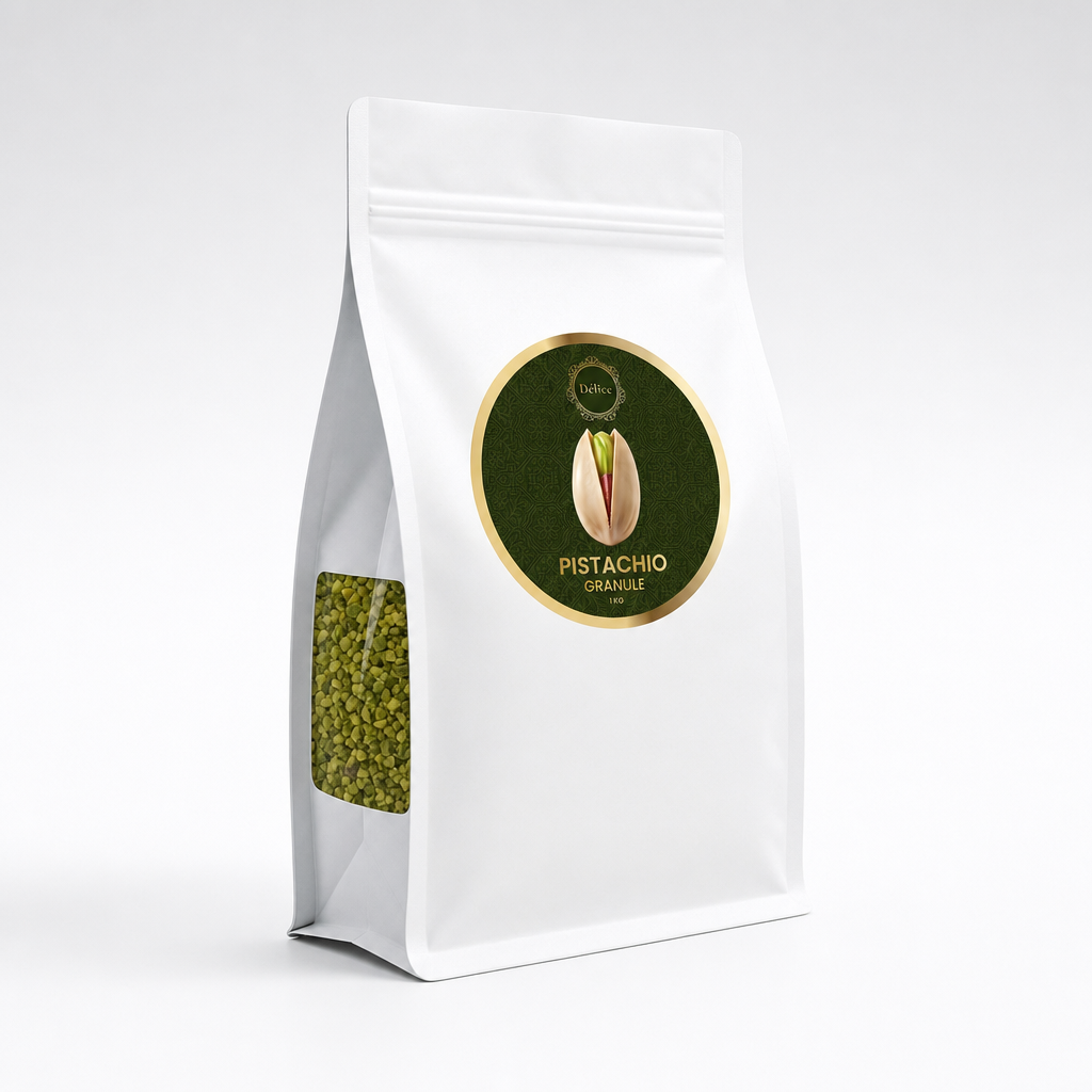 A white stand-up pouch of pistachio kernels with a clear window showing green pistachios inside. The front features a circular dark green and gold label with a pistachio illustration and the text 'PISTACHIO KERNELS, PULLED'.